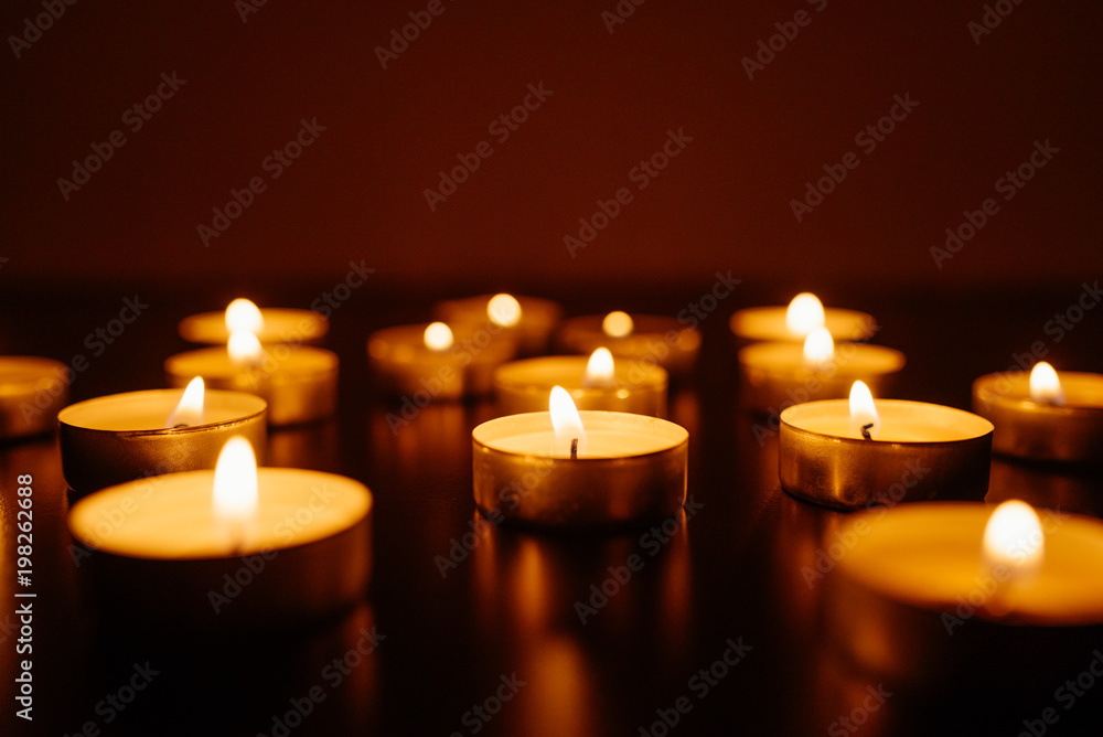 Kemerovo, Russia, fire in the mall, burning candles. Shallow depth of field. Many candles burning at night. Candles background. Many candle flames glowing on dark background. Close-up. Free space. Kemerovo, Russia, fire in the mall, burning candles. Shallow depth of field. Many candles burning at night. Candles background. Many candle flames glowing on dark background. Close-up. Free space.