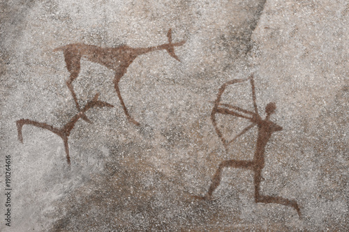 An image of an ancient hunt on a cave wall. ancient history. archeology.