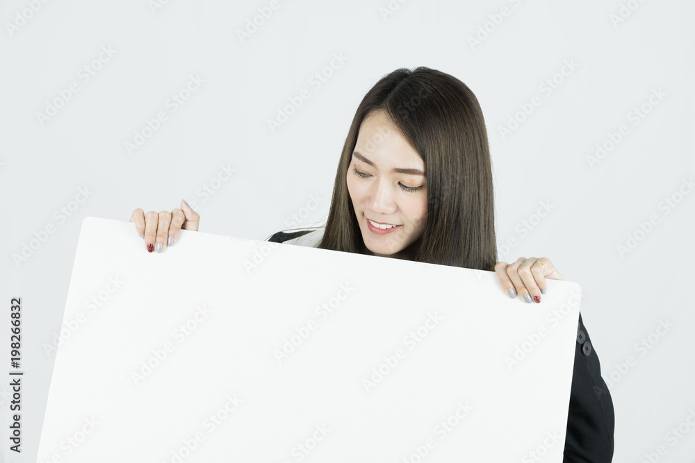 Asian businesswoman holding blank white card board sign. Asian businesswoman holding blank white card board sign.