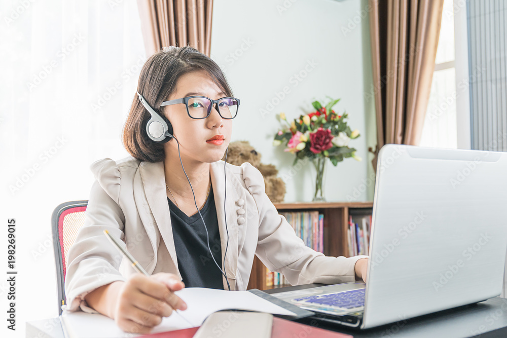 Teenage girl working on laptop in home office Teenage girl working on laptop in home office