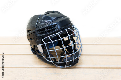 Kid's hockey helmet is on the bench. Isolated object.