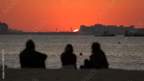 Wallpaper Mural Three people admiring the sunset from a beach Torontodigital.ca