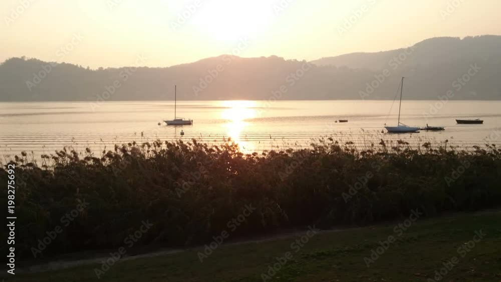 Sun setting behind the mountains on lake Como, Italy.