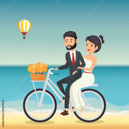 just married couple in the beach with bicycle