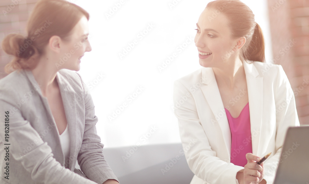 two business women discussing project cooperation two business women discussing project cooperation