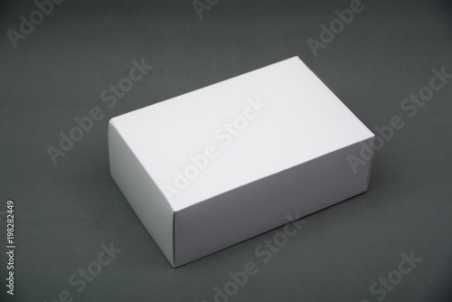 Empty Package white cardboard box or tray  for product on grey background. © pookpiik