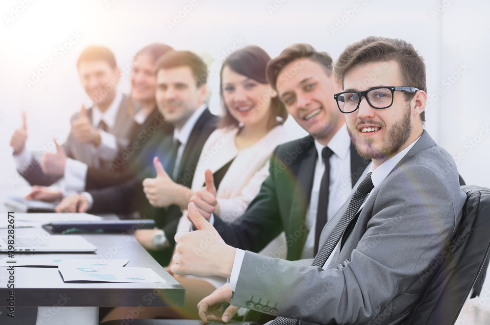 business team with thumbs up while sitting at his Desk business team with thumbs up while sitting at his Desk