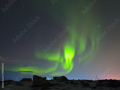 Northern lights, aurora over hills and tundra in the winter. © Moroshka