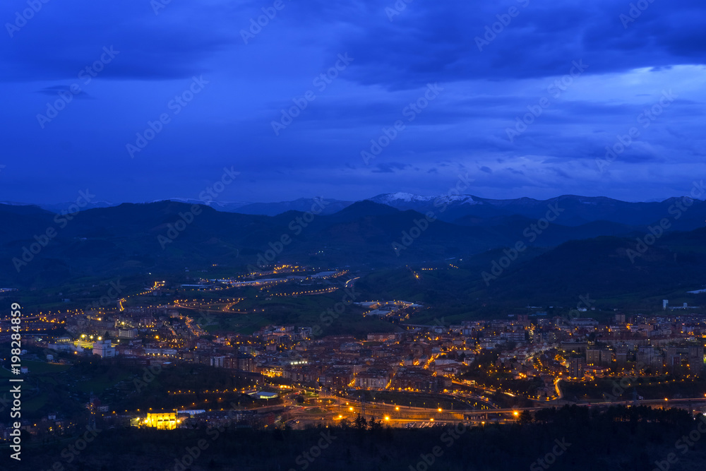Lights at sunset in the city of Renteria with the mountains in the background, Basque Country