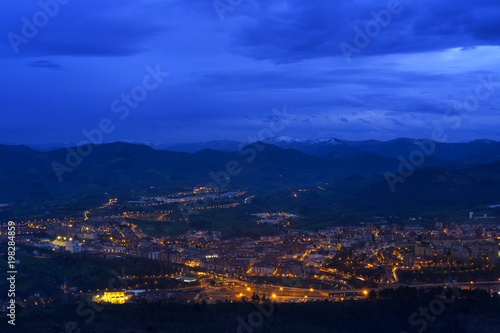 Lights at sunset in the city of Renteria with the mountains in the background, Basque Country