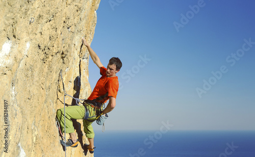 Rock-climbing in Turkey. The climber climbs on the route. Photo from the top.