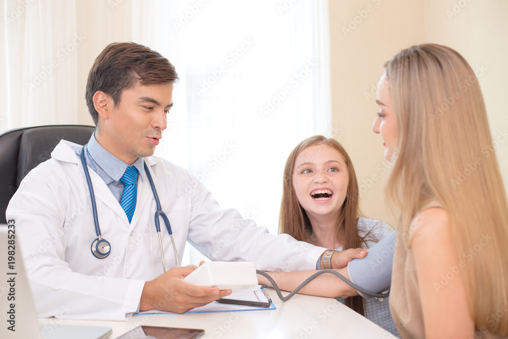 Doctor measuring blood pressure of girl patient at hospital. Healthcare and Medical concept. Doctor measuring blood pressure of girl patient at hospital. Healthcare and Medical concept.