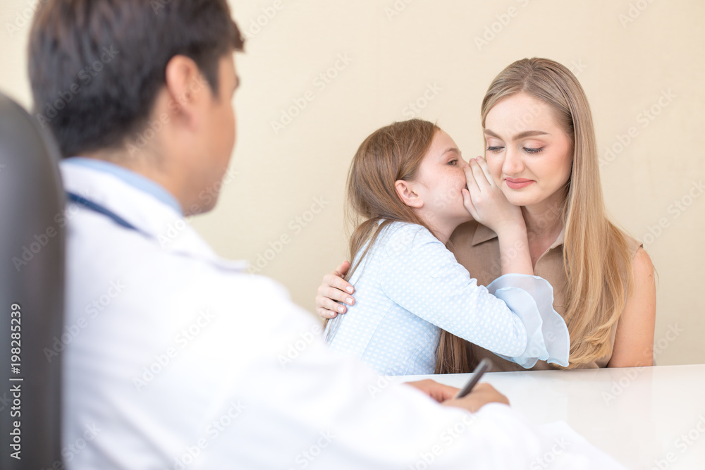 Little patient visit to doctor at clinic. Girl tell her mom for some secret. People with health care and medical concept. Little patient visit to doctor at clinic. Girl tell her mom for some secret. People with health care and medical concept.