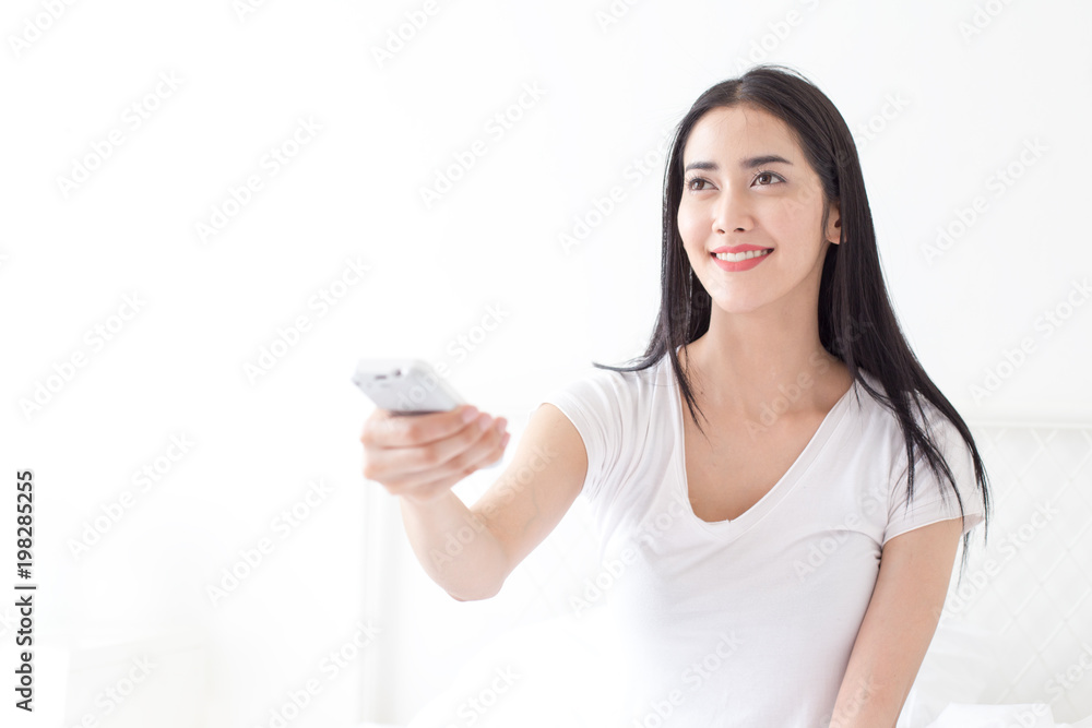 Attractive asian woman using air conditioner at home. People with lifestyle concept. Attractive asian woman using air conditioner at home. People with lifestyle concept.