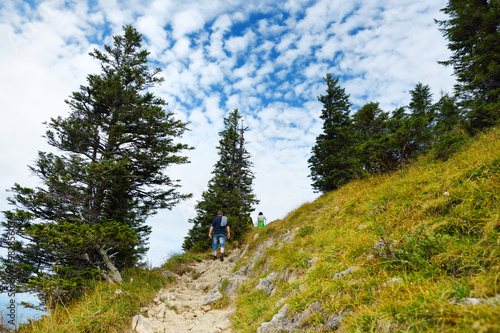 Tourists on a hiking trails of picturesque Tegelberg mountain, a part of Ammergau Alps, located nead Fussen town, Germany. photo