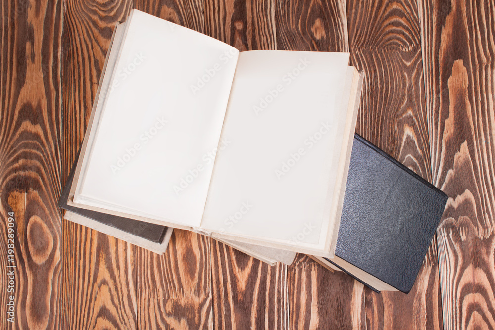 Fototapeta premium Open books on wood desk
