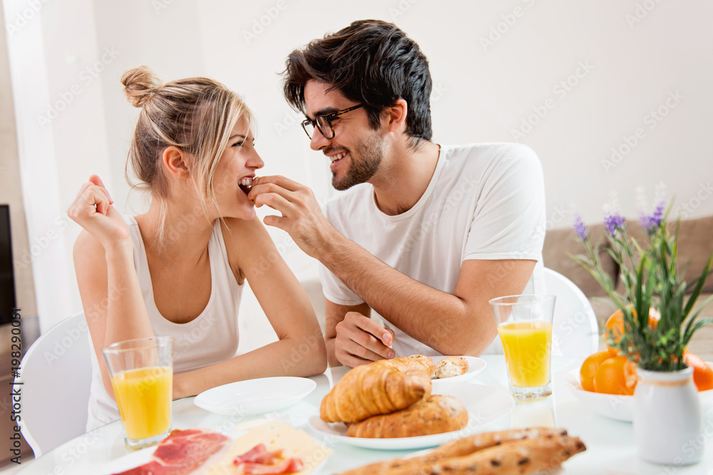 Cute young couple enjoying their breakfast together