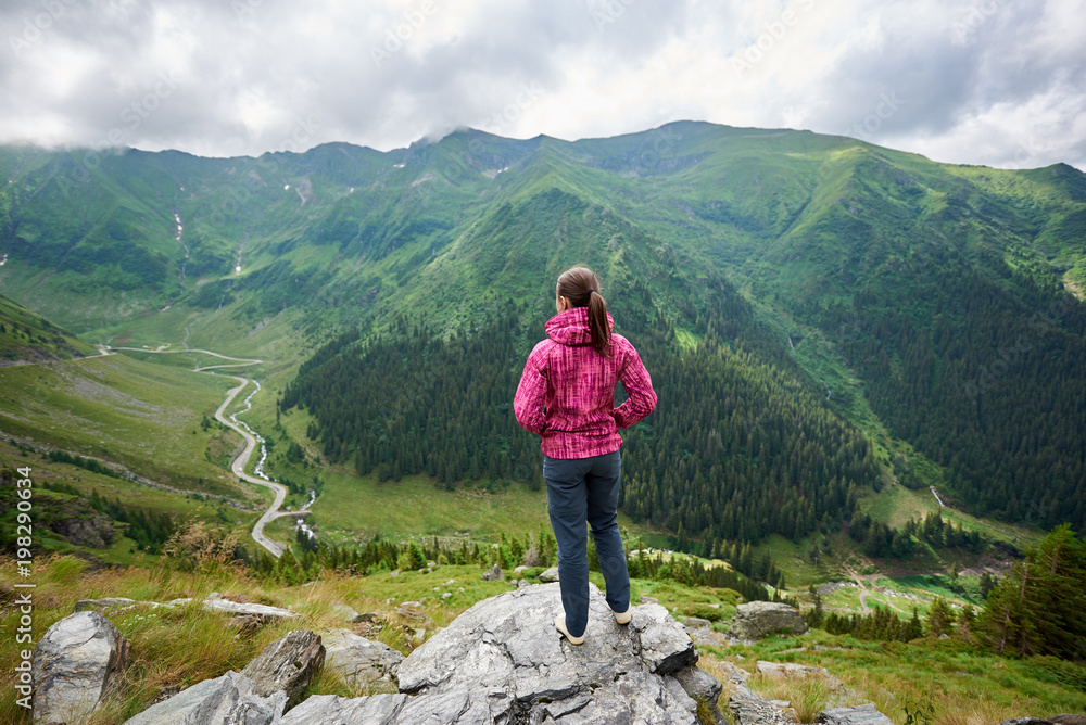 Full length shot of a female hiker standing on top of a mountain looking around copyspace beauty freedom nature achievement happiness travelling hiking active lifestyle tourism.
