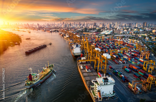 Logistics and transportation of Container Cargo ship and Cargo plane with working crane bridge in shipyard at sunrise, logistic import export and transport industry background