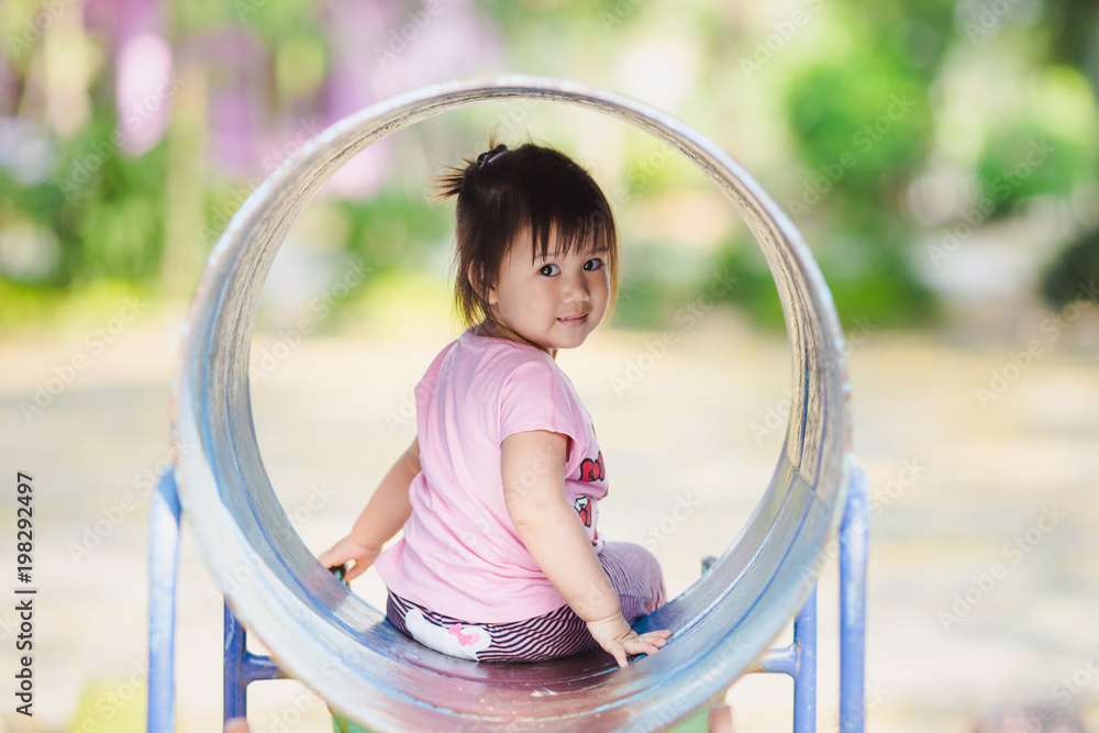 Picture of child development of 1 year and 10 months baby playing in the playground : For concept such as happy kid, learning, play and exploration. Picture of child development of 1 year and 10 months baby playing in the playground : For concept such as happy kid, learning, play and exploration.