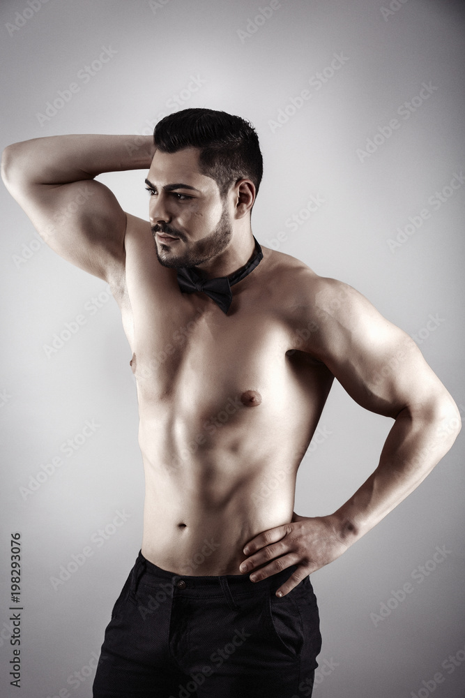 Handsome muscular man posing in studio Handsome muscular man posing in studio