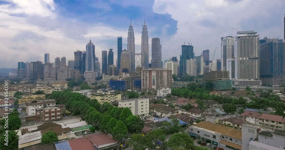 Aerial Panorama of Petronas Towers and KL Tower, Kuala Lumpur at sunrise. It is the tallest twin towers in world.