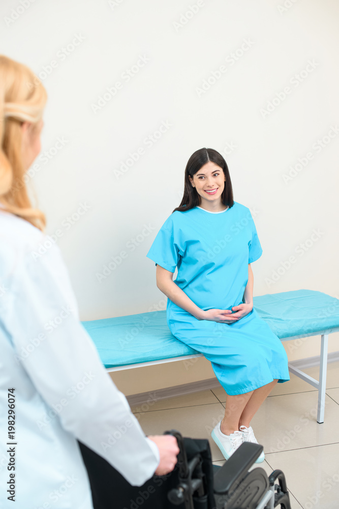 obstetrician gynecologist with wheelchair for pregnant woman obstetrician gynecologist with wheelchair for pregnant woman