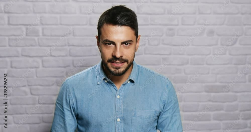 Facial Expressions Of Young Beard Man On Brick Wall Facial Expressions Of Young Beard Man On Brick Wall
