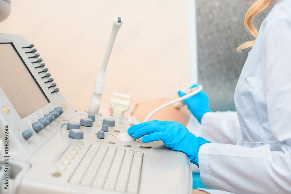 cropped shot of obstetrician gynecologist making ultrasound examination for pregnant woman cropped shot of obstetrician gynecologist making ultrasound examination for pregnant woman