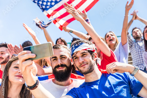 American fans taking a selfie at stadium during a match