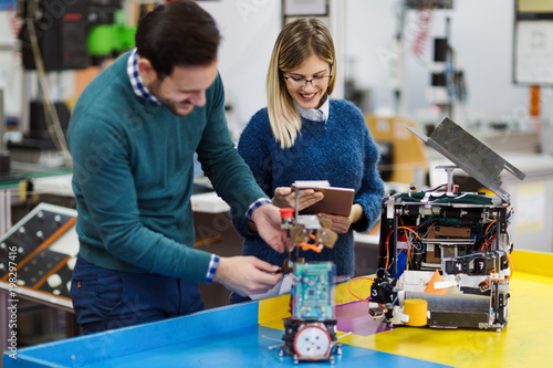 Young students of robotics working on project