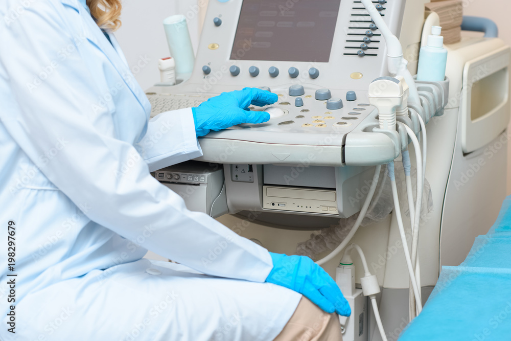 cropped shot of obstetrician gynecologist working with ultrasonic scanner cropped shot of obstetrician gynecologist working with ultrasonic scanner