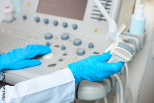 cropped shot of obstetrician gynecologist in gloves working with ultrasonic scanner