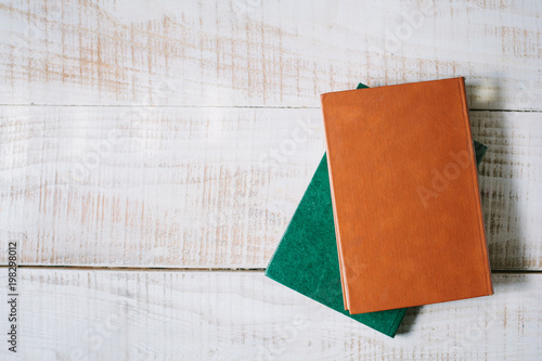 green books lie on a wooden table. top view. layflat