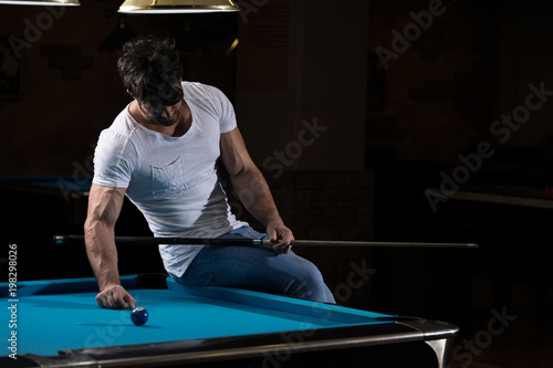 Young Man Looking Confused At Billiard Table