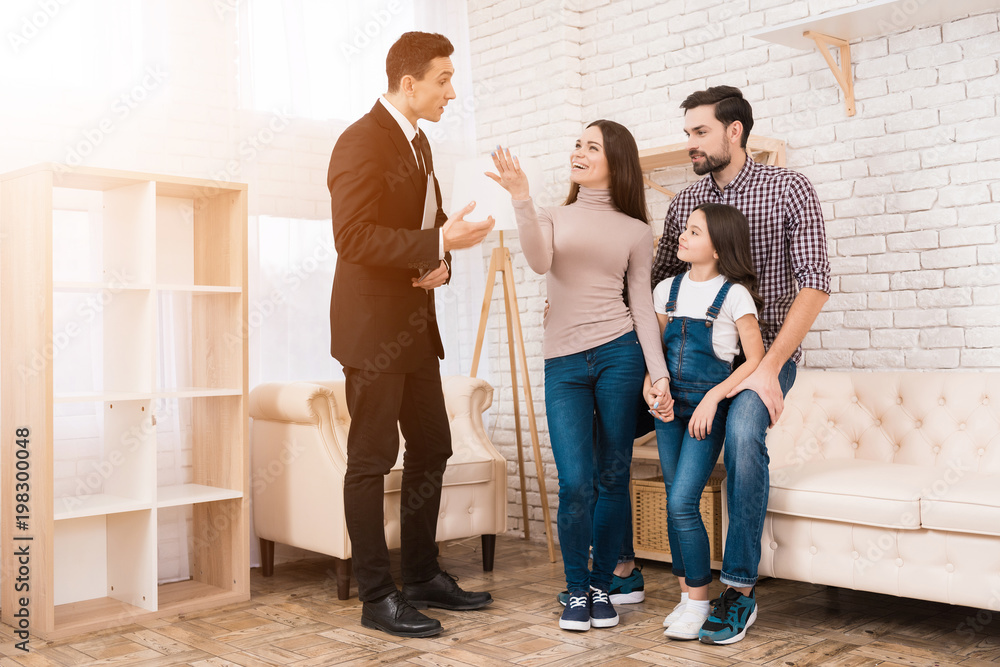 Fototapeta premium Realtor in suit shows family house they bought. Concept of buying house. Buying real estate.