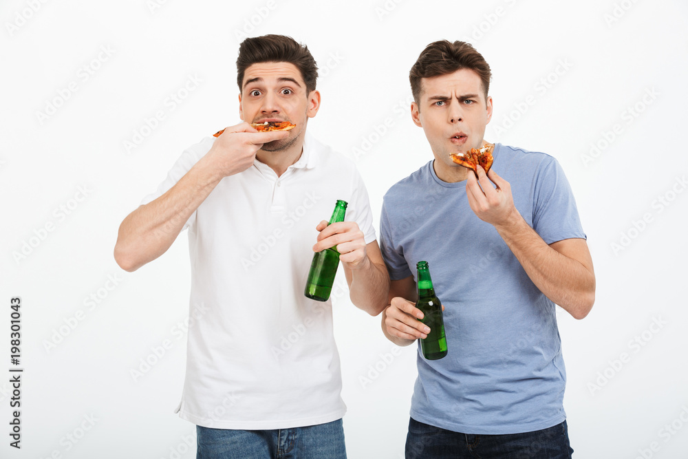 Portrait of two funny young men celebrating Portrait of two funny young men celebrating