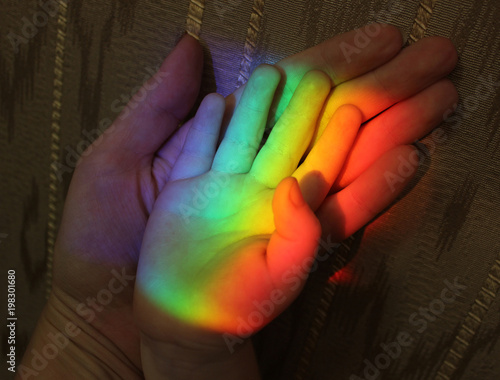 family hands and rainbow