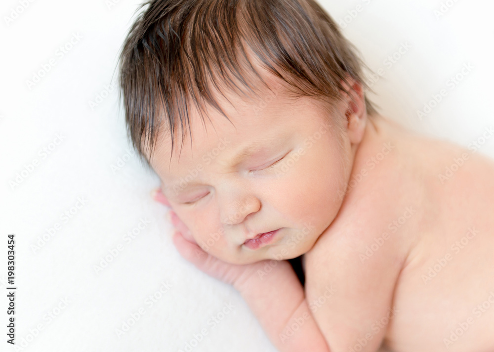 Sweet newborn baby sleeping on white blanket Sweet newborn baby sleeping on white blanket