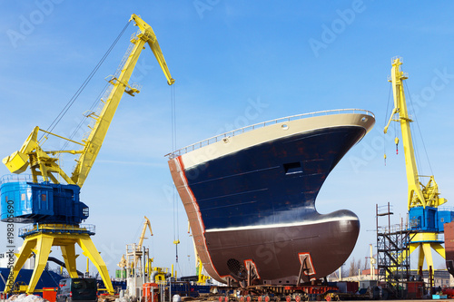 Fotografering Ship construction and crane in a shipyard