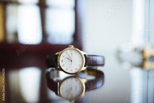 Golden Watch on Glass Table