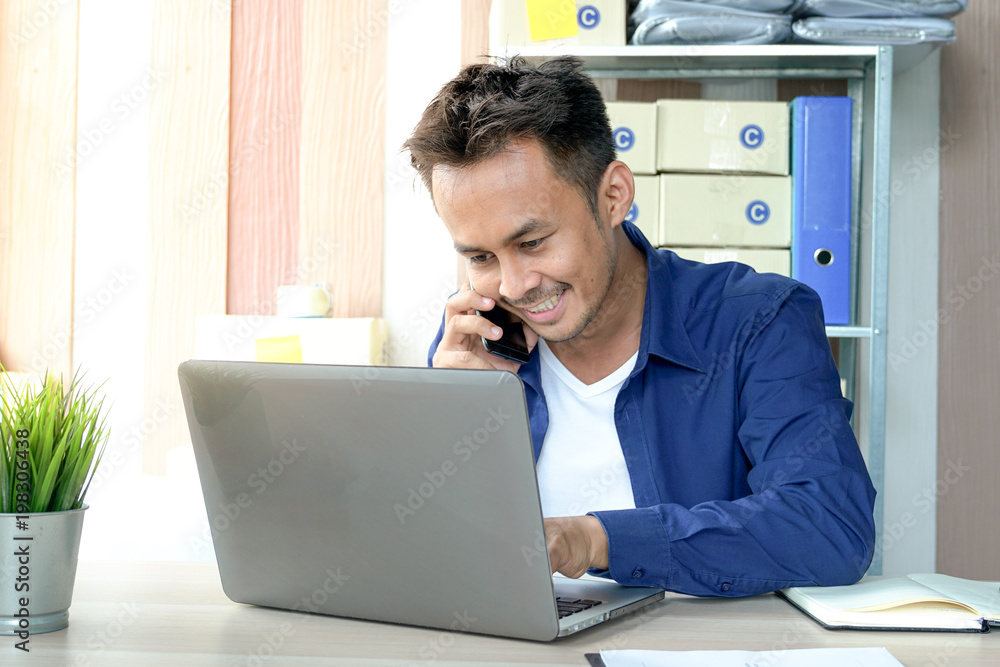 Young business owner of the SME start up company are get purchase orders from customers in the online trading business with a computer laptop in the Home Office Young business owner of the SME start up company are get purchase orders from customers in the online trading business with a computer laptop in the Home Office