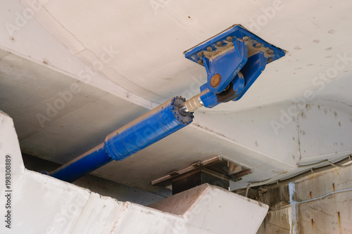 under bridge massive Hydraulic damper used to dissipate the large amounts of energy that result from sudden dynamic loading like earthquakes.