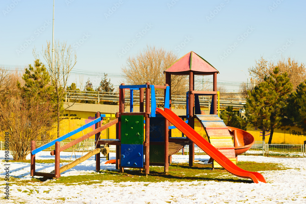 Vivid colors, empty childrens playground in winter time. Vivid colors, empty childrens playground in winter time.