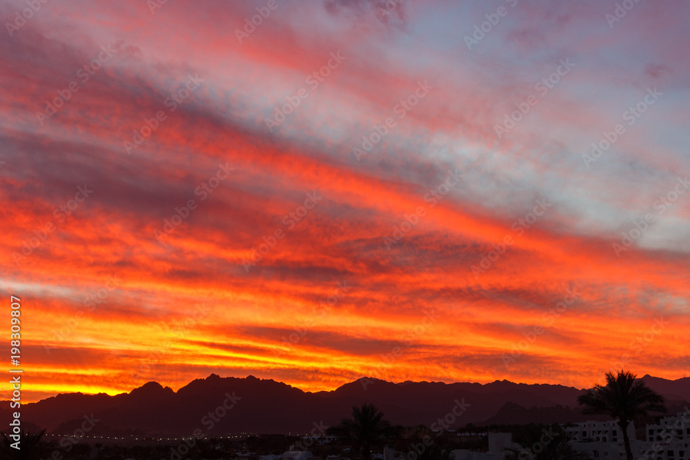 Colorful orange sunset over the mountain hills