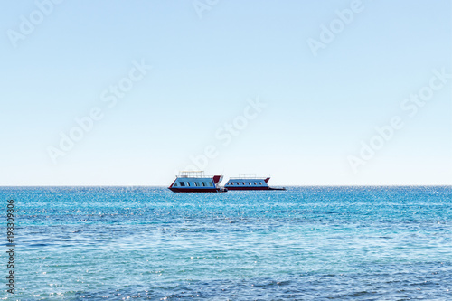 The ship sails on the sea. tourist boat. Sea ships against the background of a beautiful sky