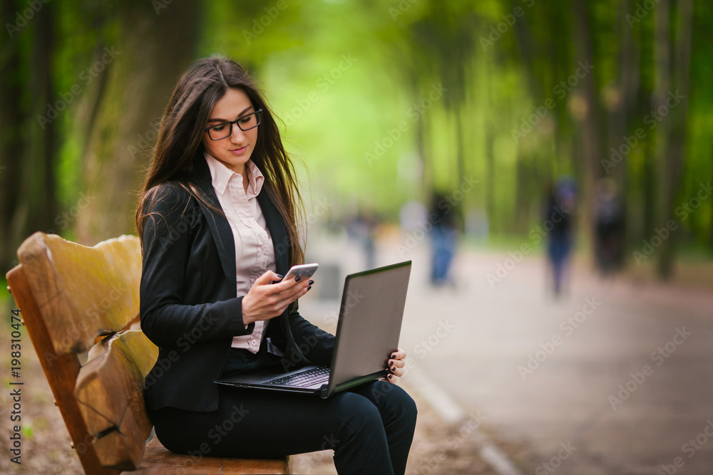girl in glasses sits on a bench girl in glasses sits on a bench