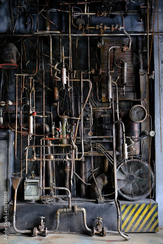 Dark industrial interior with metal rusty old pipes