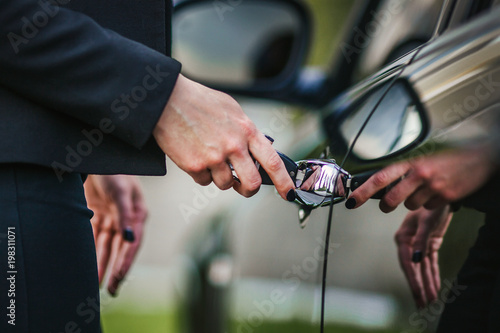 the woman opens the car with the key