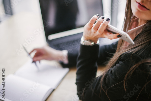 busy brunette with phone in her hand